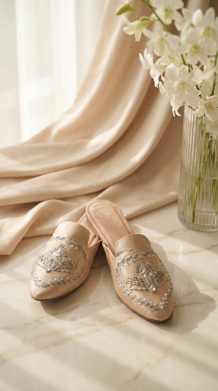 Radiant nude zardozi mule flat by Radiarte – silver bugle bead embroidery side view on marble