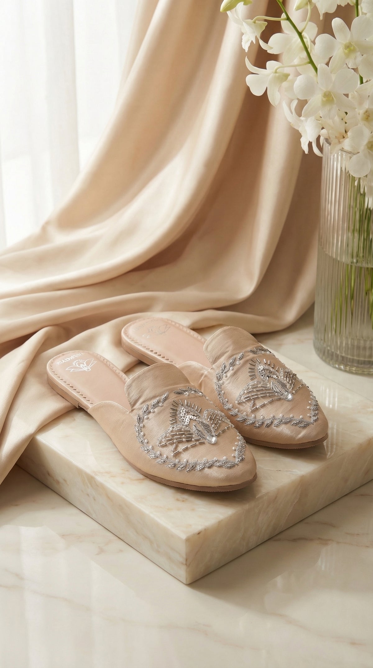 Radiant nude embroidered flat mule on marble platform – handcrafted women's footwear Radiarte