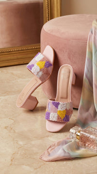 Phulkari Handcrafted Punch Needle Mule Heel – Side View with Pink Ottoman & Pastel Scarf by Radiarte