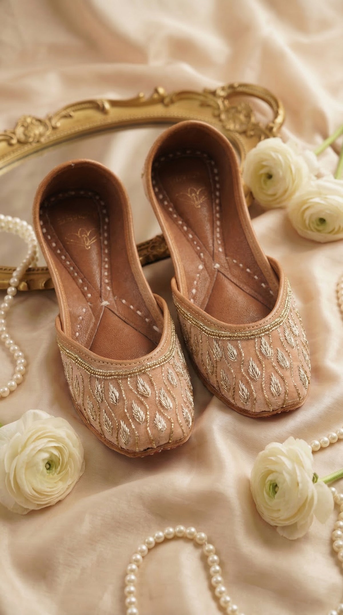 Noor Nude Beige Silver Gold Leaf Zardozi Jutti by Radiarte – Flat Lay with Gold Mirror & White Roses