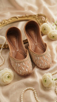 Noor Nude Beige Silver Gold Leaf Zardozi Jutti by Radiarte – Flat Lay with Gold Mirror & White Roses