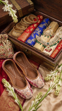 Mirage Blush Jutti Pair – Flat Lay with Banarasi Sarees & Bridal Jewellery by Radiarte