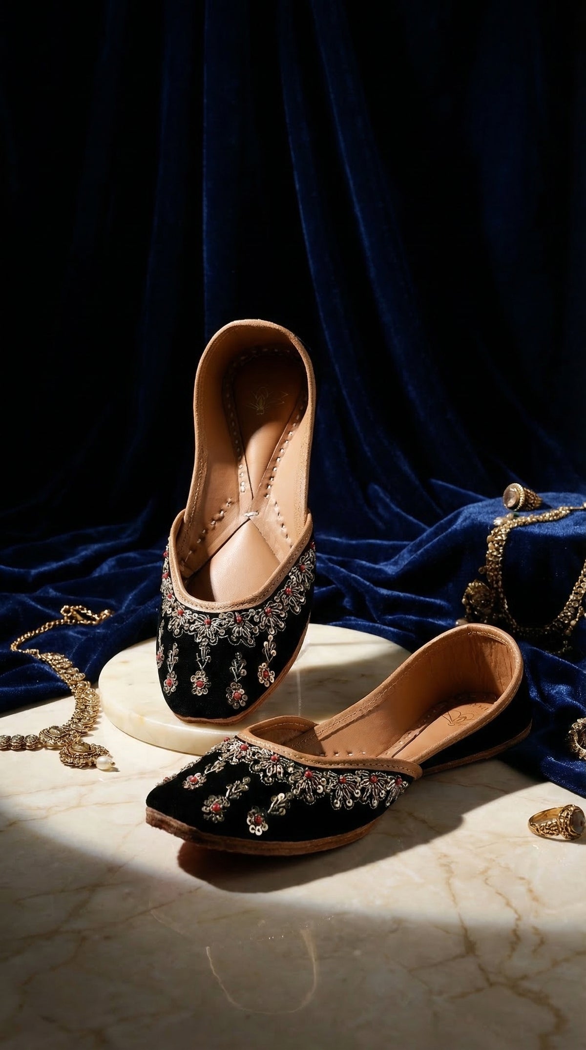 Zehra black velvet silver zardozi ruby jutti by Radiarte – pair on marble with navy velvet and gold jewellery