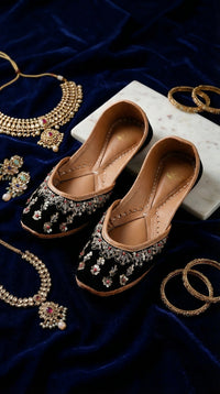 Zehra black velvet embroidered jutti pair – display on navy velvet with kundan necklace and gold bangles Radiarte