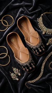 Zehra black velvet chandelier motif jutti – top view flat lay on black velvet with gold bangles and necklaces Radiarte
