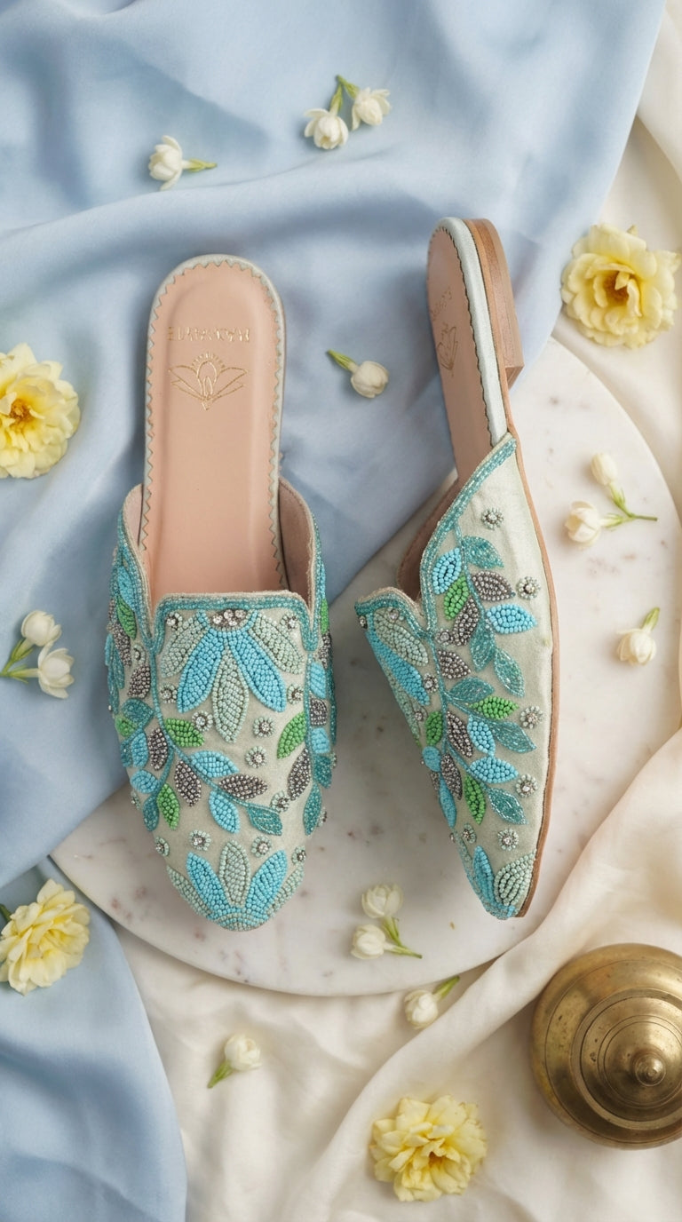 Whispering Skies blue crystal beaded mule flat – split display on marble tray with yellow roses and brass Radiarte