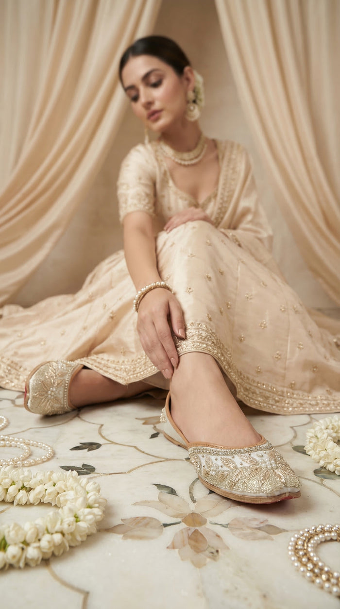 Tara ivory bridal jutti on feet – worn with champagne tissue lehenga in bridal setting with jasmine Radiarte