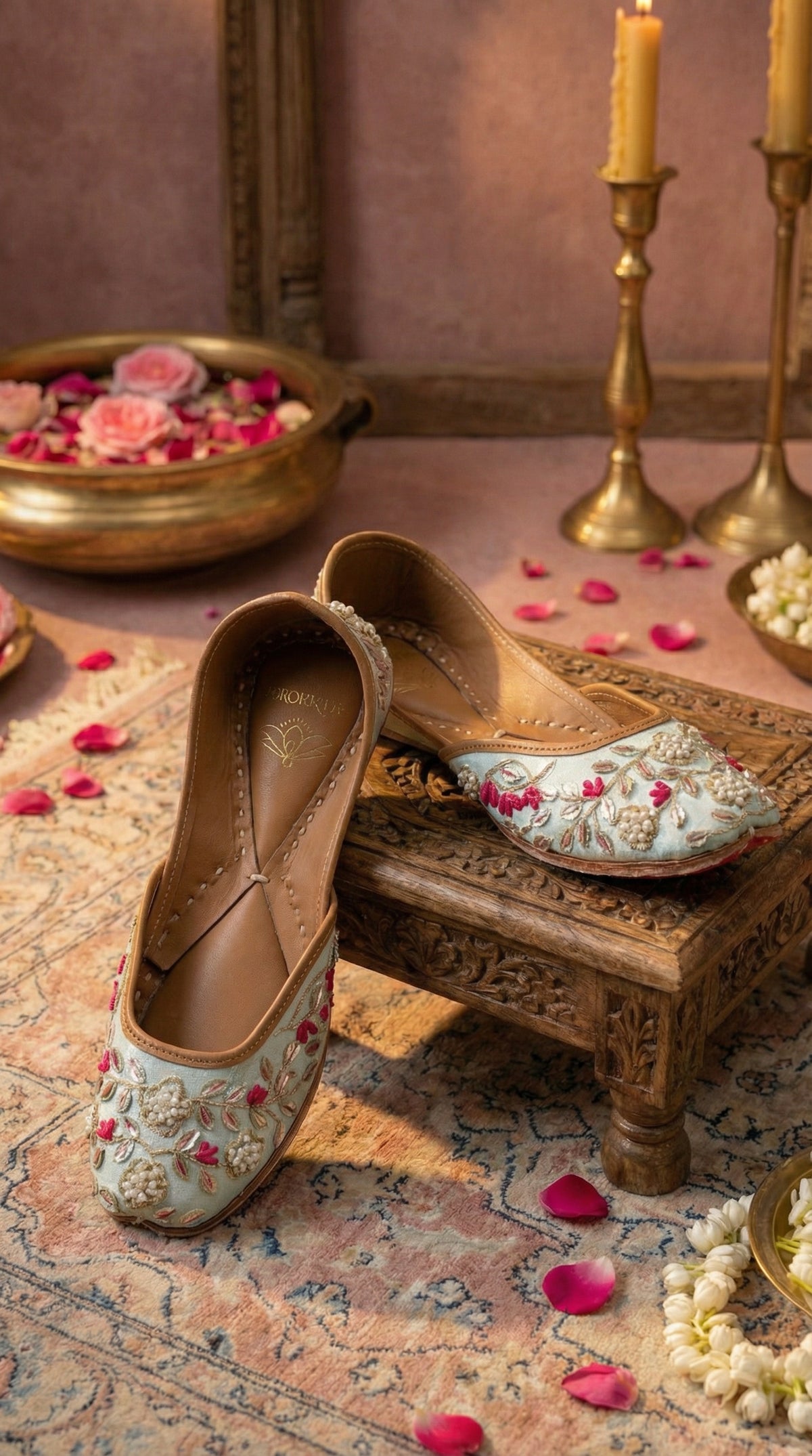 Samundar powder blue embroidered jutti – side view on carved wooden chowki with rose petals by Radiarte