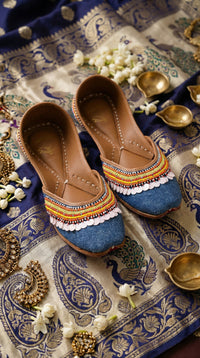 Zyra denim blue rainbow seed bead jutti by Radiarte – top view on Banarasi silk with brass diyas and mogra