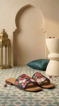 Rangrez navy floral embroidered slide flat by Radiarte – pair view on Moroccan tile with brass lantern