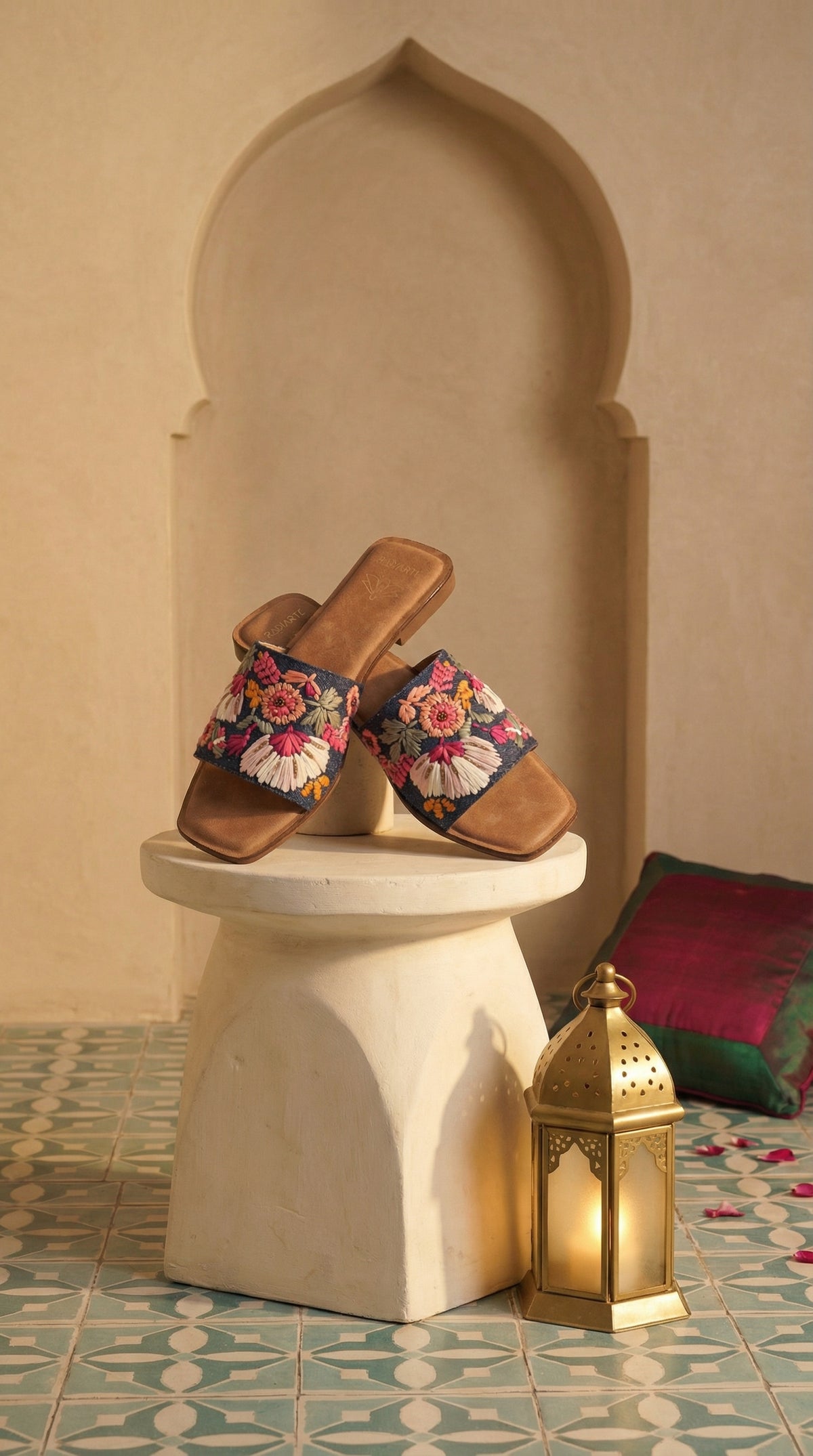 Rangrez handcrafted multicolour floral slide flat – elevated display on white pedestal with gold lantern