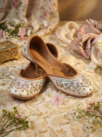 Noorani Handcrafted Ivory Jutti with Pastel Sequins & Gold Zardozi – Side View with Florals by Radiarte