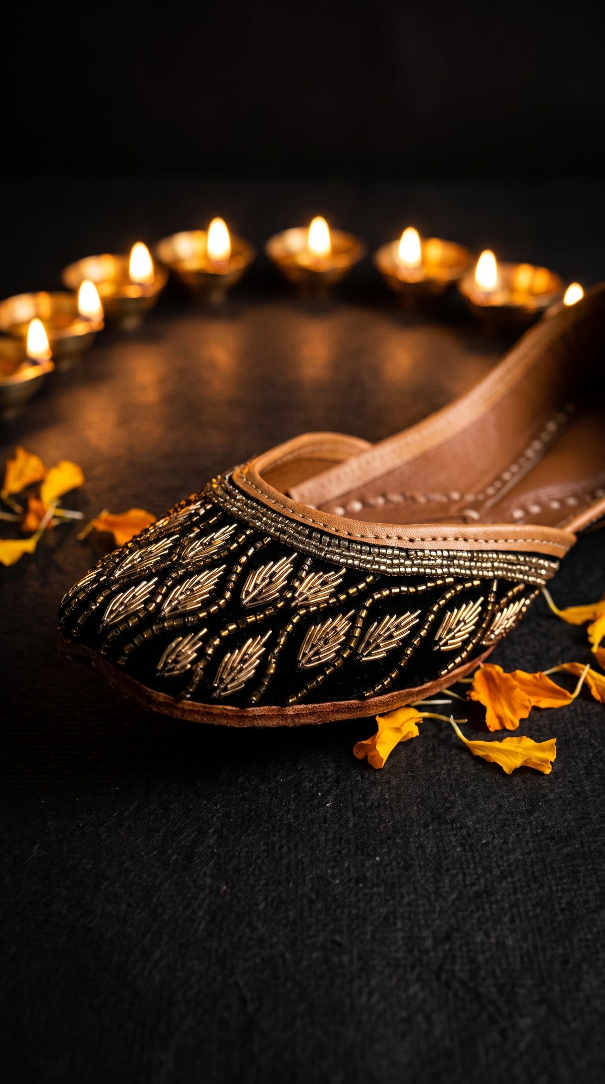Shabnoor jutti with diya and marigold petals festive flat lay
