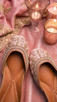 Nazakat Handcrafted Pink Jutti Close-Up with Pearl Clusters & Gold Zardozi – Candle Flat Lay by Radiarte