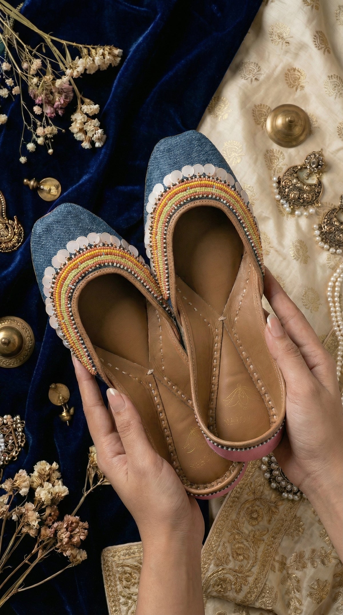 Zyra denim multicolour rainbow jutti held in hands – close-up showing full bead work detail with jewellery Radiarte