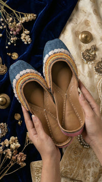 Zyra denim multicolour rainbow jutti held in hands – close-up showing full bead work detail with jewellery Radiarte