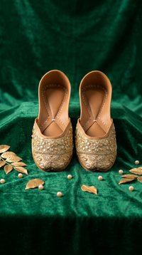 Zarrin gold zardozi embroidered jutti pair on emerald green velvet with gold leaves and pearls
