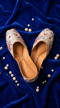 Samundar handcrafted bridal jutti – top-down view of mirror work and red thread embroidery on royal blue velvet with pearls